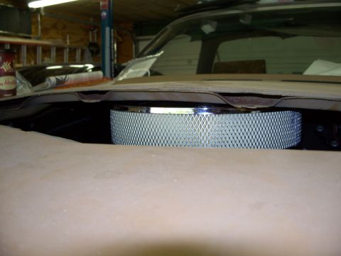 1971 Ford Ranchero - Close-up of a chrome air cleaner assembly visible under the hood of a vehicle.