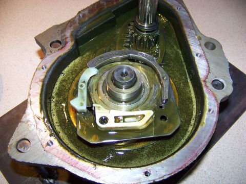 1994 Ford F-150 - Close-up view of internal transmission components, including gears and a splined shaft, submerged in oil.