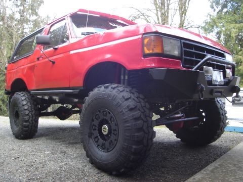 1989 Ford Bronco - This lifted Ford Bronco features large off-road tires and a custom front bumper.