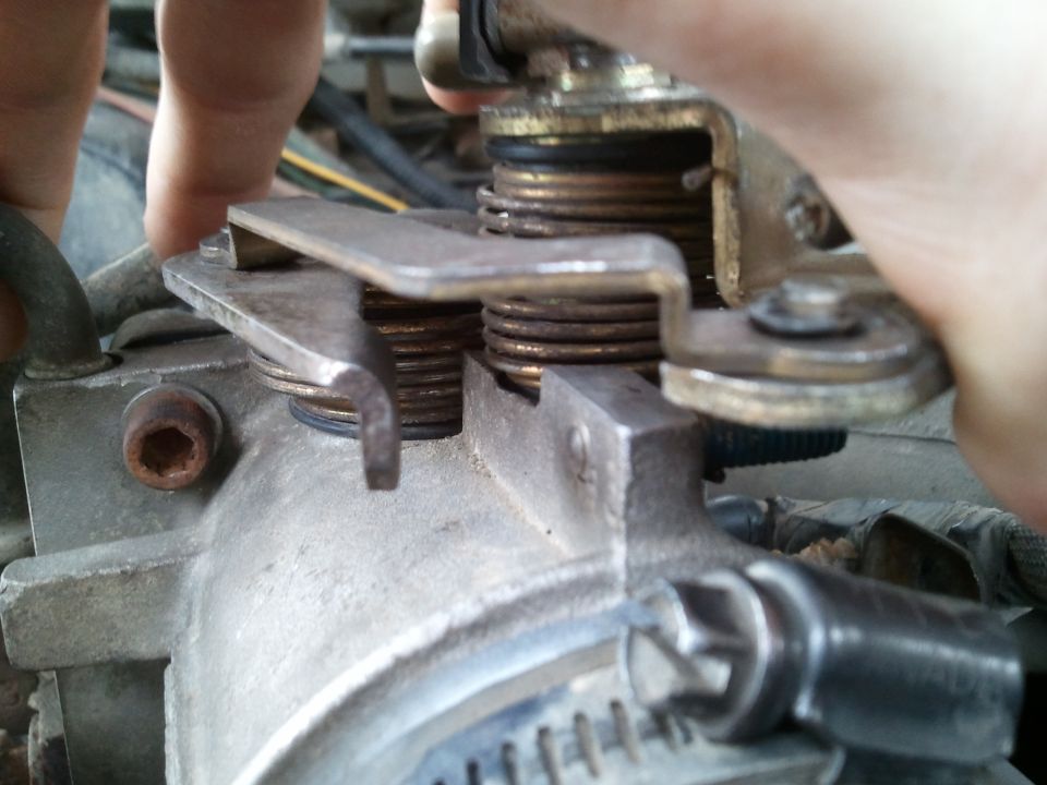 Close-up of throttle body linkage with springs and lever