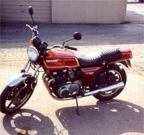2008 Ford Crown Victoria - Kawasaki KZ1000 motorcycle with a red fuel tank and gold pinstripes.