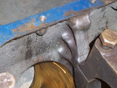1969 Ford Torino - A close-up view of an engine block casting, revealing internal mechanical components and some surface wear.