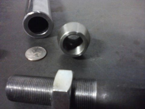 1971 International School Bus - Close-up of metal rod, nut, and other components, with a coin for scale.