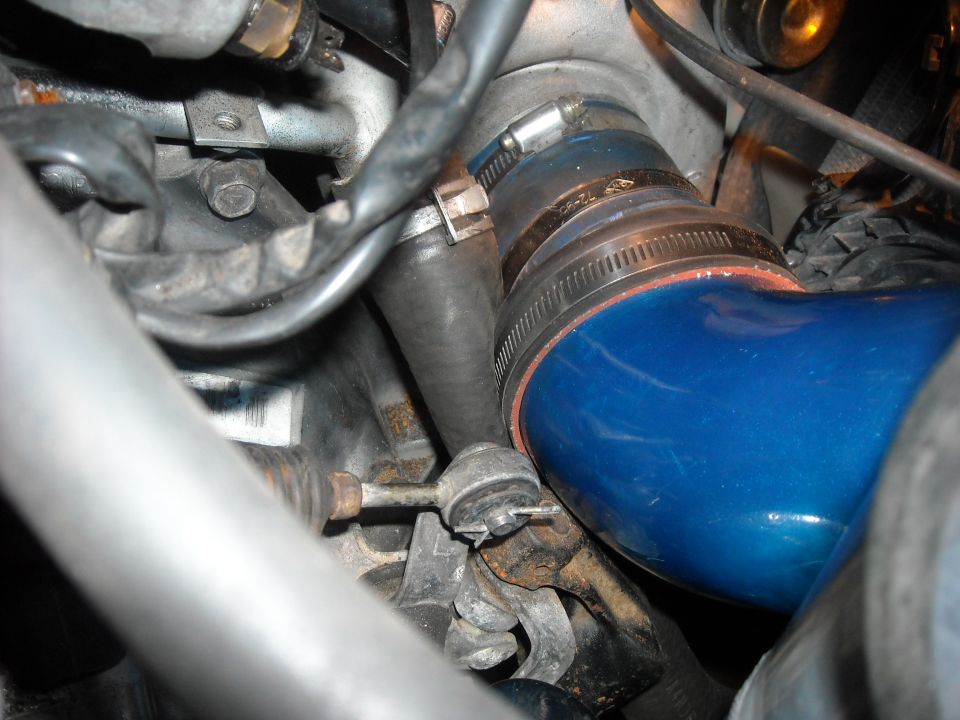 Blue silicone intake coupler clamped to a ribbed hose in a dirty engine bay