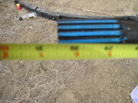 1978 Ford Bronco - A leaf spring is shown with blue painted ends and a yellow tape measure for scale.