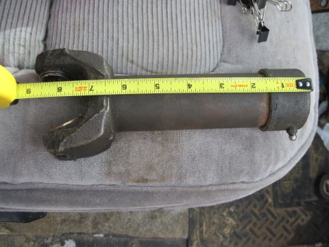 1978 Ford Bronco - A driveshaft part is measured with a tape measure, showing approximately 7 inches.