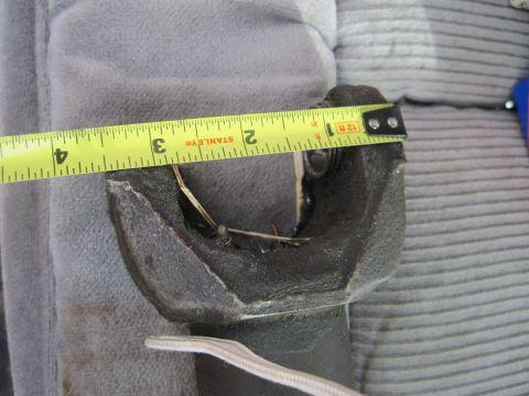 1978 Ford Bronco - Measuring a driveshaft part with a tape measure. The part appears to be a yoke.