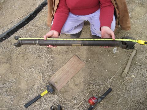 1978 Ford Bronco - Driveshaft being measured on the ground with tools nearby.