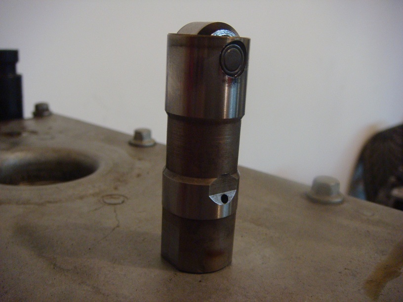 Engine lifter with roller tip, close-up view
