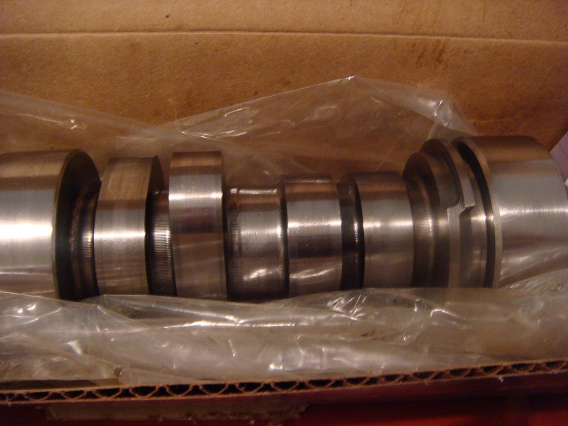 New camshaft in plastic sleeve inside cardboard box, polished journals and lobes