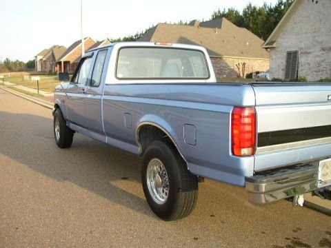 1995 Ford Bronco - This blue pickup truck appears to be from the early to mid-1990s, not a 1995 model.