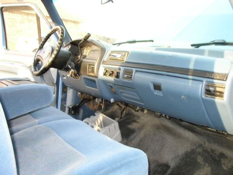 1995 Ford Bronco - Interior view of a truck's dashboard and seating area, showing the steering wheel and radio.