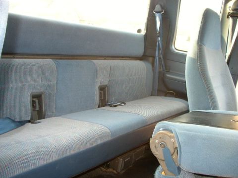 1995 Ford Bronco - The interior of a 1995 Ford Bronco shows a rear bench seat with blue patterned upholstery.
