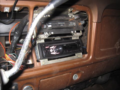 1979 Ford Bronco - Aftermarket JVC stereo installed in the dashboard, with climate controls above and visible wiring.
