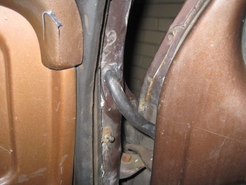 1979 Ford Bronco - Close-up of the door jamb on a 1979 Ford Bronco, revealing the interior metalwork and weather stripping.