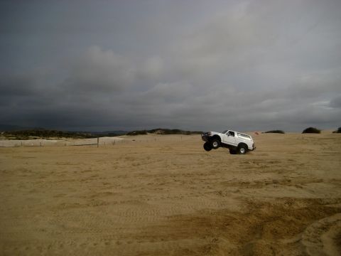 1996 Ford Bronco - White 1996 Ford Bronco airborne during a jump over sand dunes.
