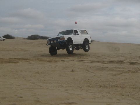 1996 Ford Bronco - This modified 1996 Ford Bronco is captured mid-air while traversing sand dunes.