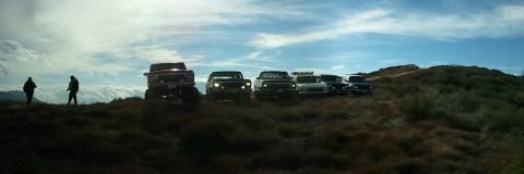 1978 Ford Bronco - A group of off-road vehicles gathered on a scenic overlook.