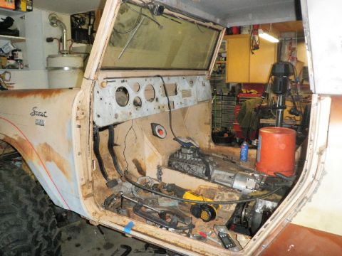 1961 International Scout 800 - The interior of a 1961 International Scout 800 is shown during restoration, with the dashboard and transmission tunnel exposed.