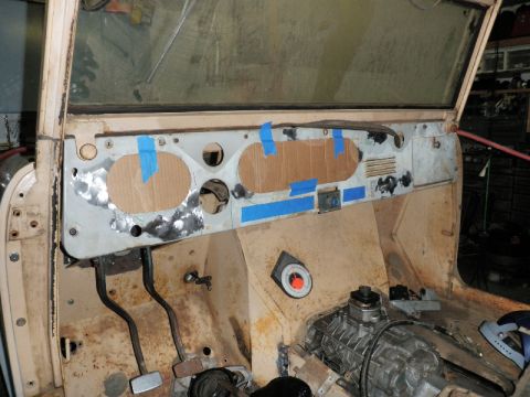 1961 International Scout 800 - Interior view of a vehicle's dashboard and transmission, showing cardboard templates for gauge cutouts.