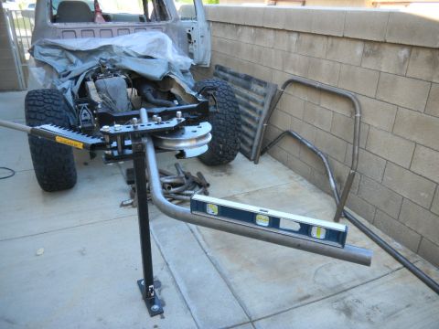 1997 Ford Ranger - A truck chassis is being worked on with a pipe bender and roll cage components nearby.