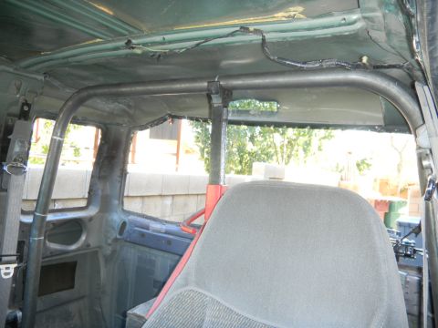 1997 Ford Ranger - Custom roll cage installed inside a vehicle's interior, with a grey seat visible.