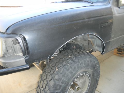 1997 Ford Ranger - Front fender and wheel of a 1997 Ford Ranger, showing modifications to the wheel well.