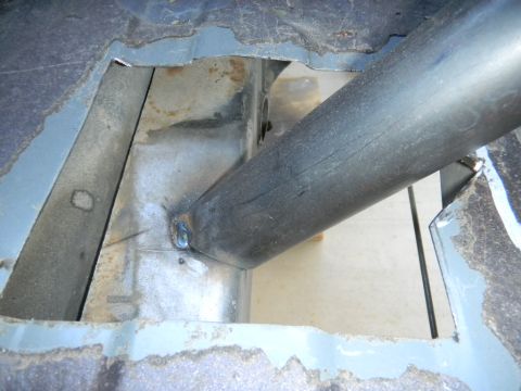 1997 Ford Ranger - This image shows a close-up view of a roll cage tube being welded to the frame of a vehicle, indicating custom modifications.