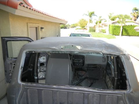 1997 Ford Ranger - The interior of a Ford Explorer is visible with the roof removed and doors ajar, revealing its internal structure and dashboard.