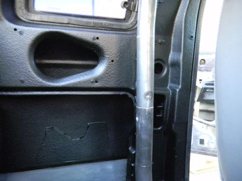1997 Ford Ranger - The interior of the vehicle shows textured black panels and a silver support pole.