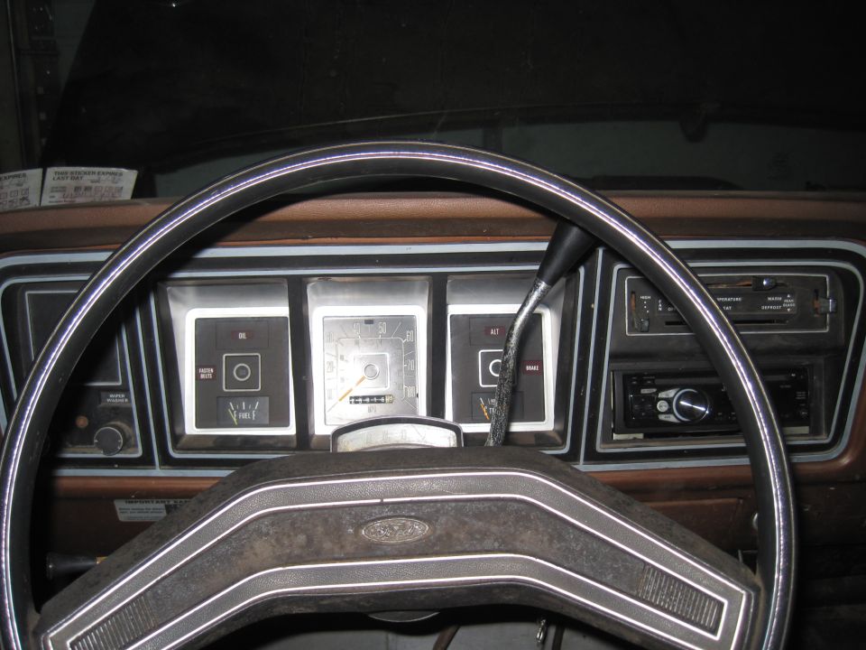 1979 Ford Bronco interior showing dashboard gauges, steering wheel, and radio