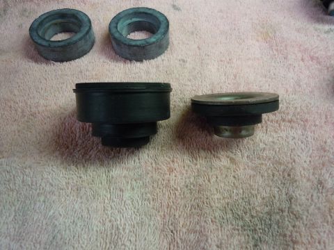 1970 Chevrolet Camaro - Several rubber and metal automotive parts are laid out on a textured pink surface.