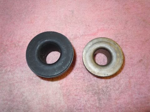 1970 Chevrolet Camaro - Comparison of two metal bushings, one rubber and one metal, displayed on a pink towel.