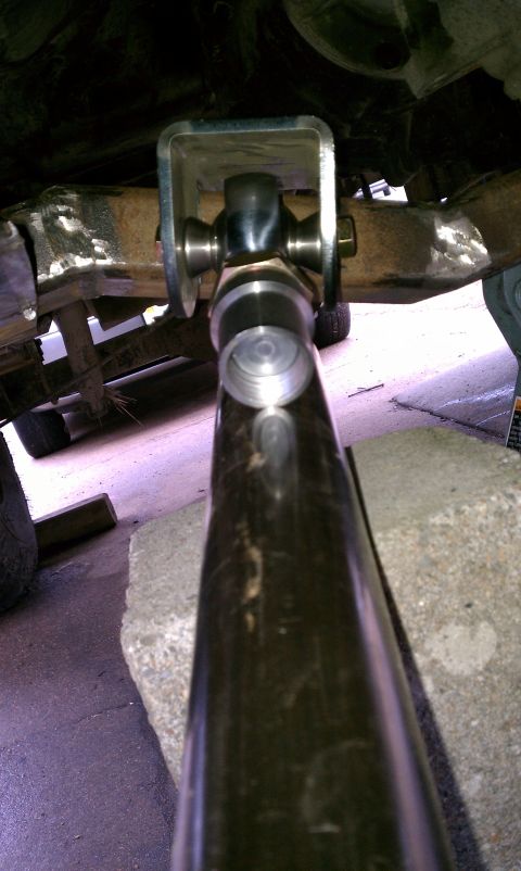 1990 Ford Bronco - A close-up view of a vehicle's suspension system, focusing on a metal component.