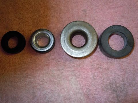 1970 Chevrolet Camaro - Four assorted bushings laid out on a pink towel. One has a visible part number.