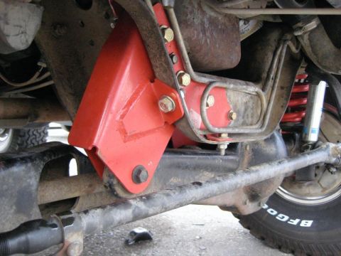 1900 Yugo GVX - Undercarriage view shows a red suspension component and a portion of a tire with visible text.
