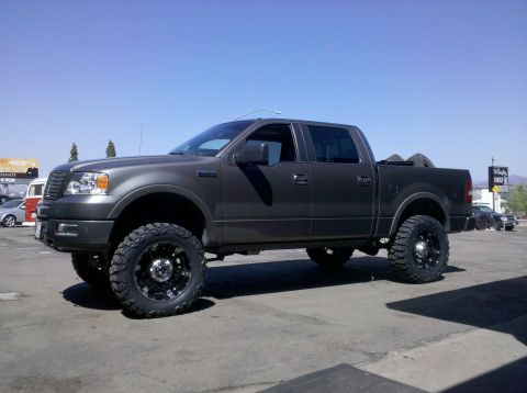 2005 Ford F-150 - This lifted pickup truck has aftermarket wheels and tires, and appears to be a 2004 model year.
