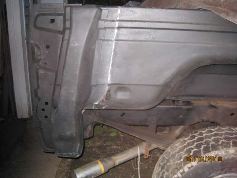 1983 Ford Bronco - This photo shows the rear quarter panel of a Ford Bronco, with visible suspension and bodywork details.