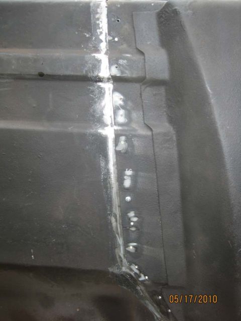 1983 Ford Bronco - Close-up of a welded seam on a black metal panel, likely a vehicle part.