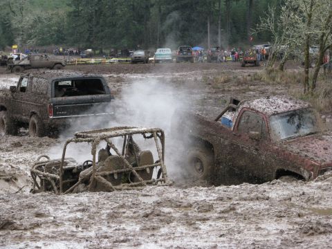 1978 Ford Bronco - A 1978 Ford Bronco navigates a muddy obstacle course with other vehicles.