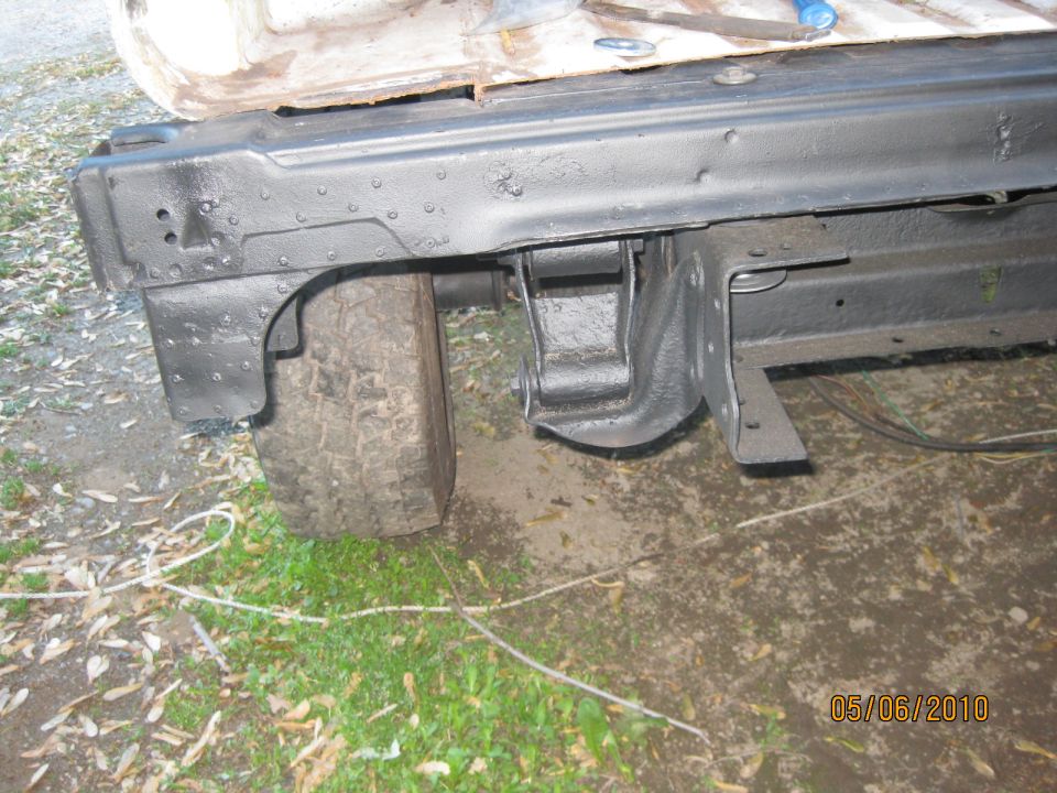 Black-painted body rails and inner wheel house panels leaning against a knobby tire