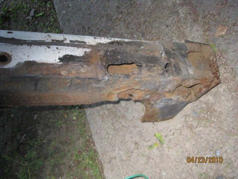 1983 Ford Bronco - A corroded vehicle frame component shows significant deterioration and damage.