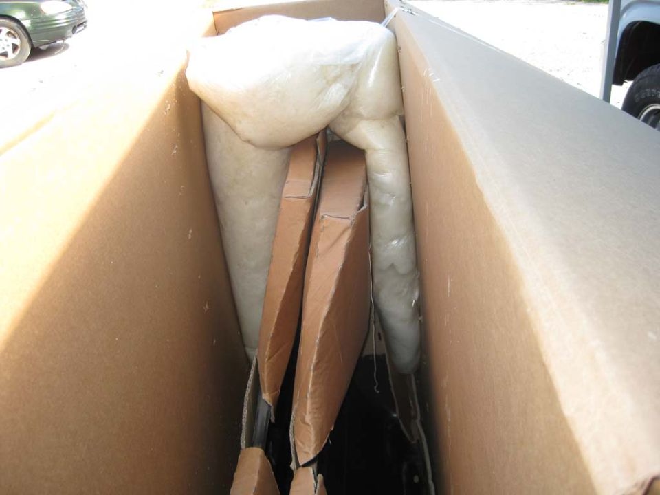 White foam padding in a cardboard box in a truck bed