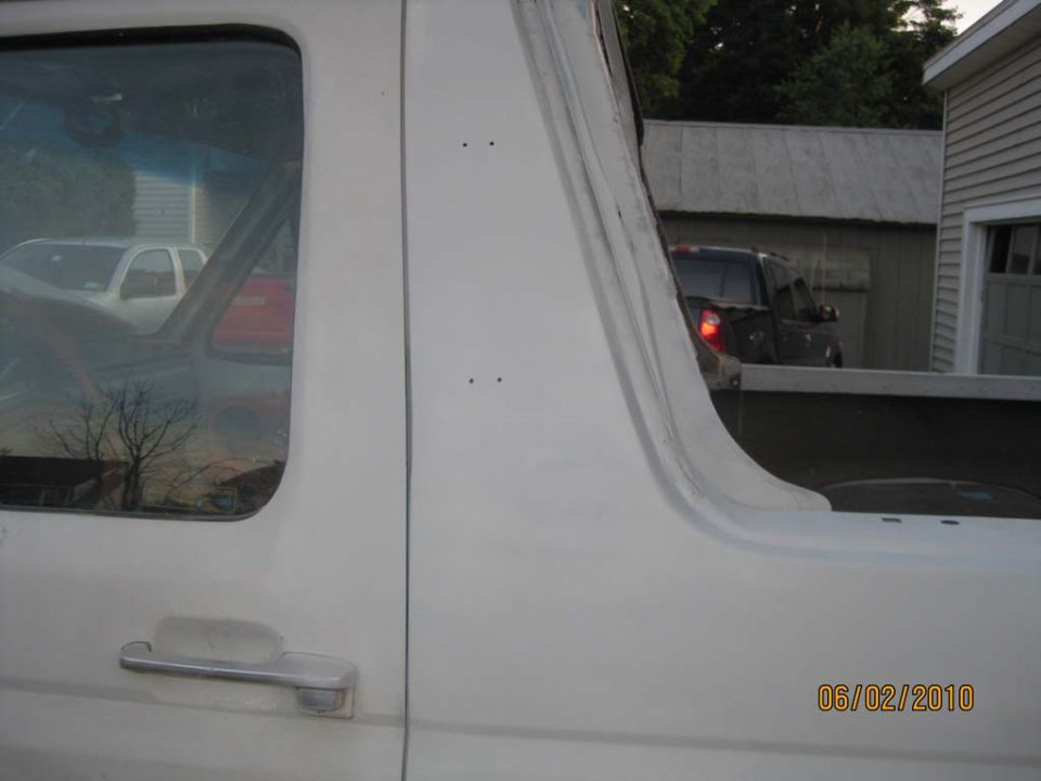 White Bronco B-pillar and rear tub panel seam blended in primer, chrome door handle