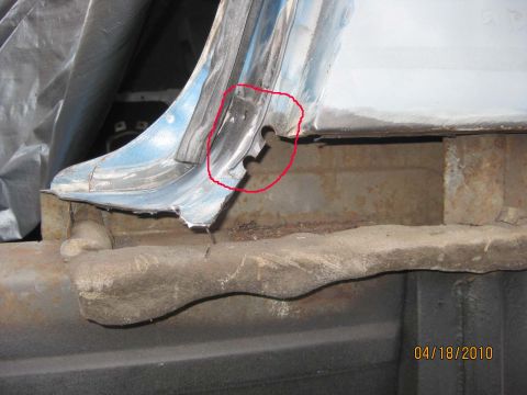 1983 Ford Bronco - Detail of a cut-open body seam during quarter-panel removal, with a red circle drawn on the photo to point out the notched flange and spot-…