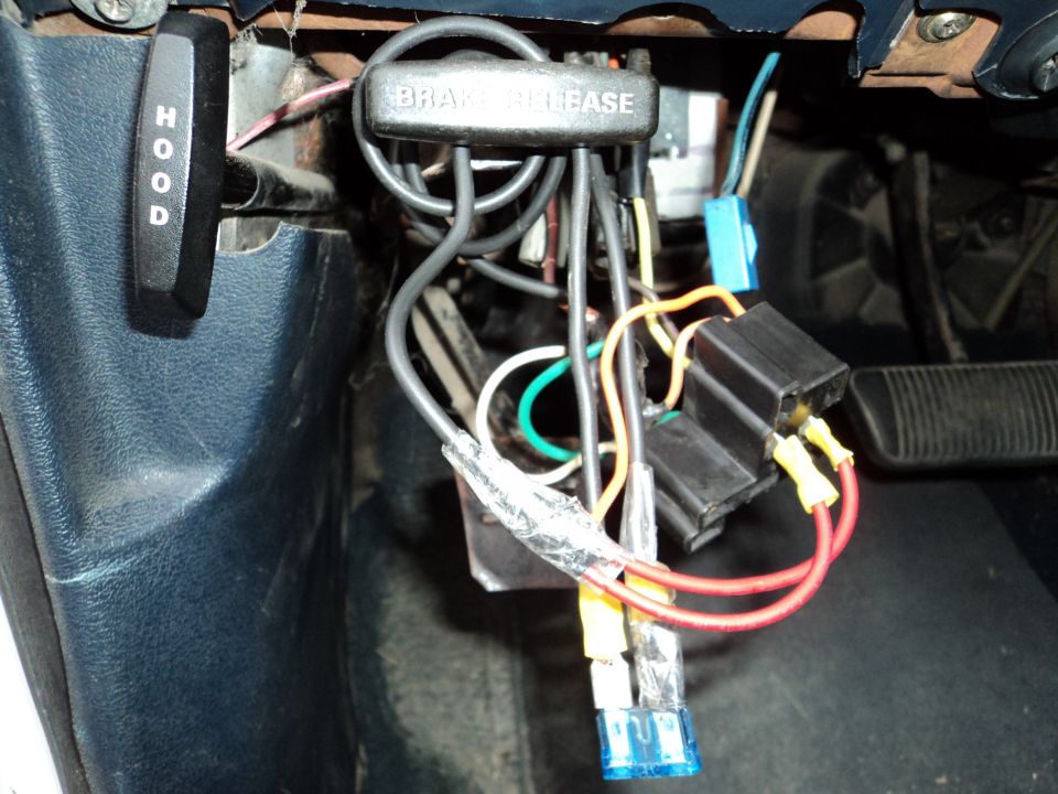 Interior wiring harness and brake release lever with 'HOOD' lever visible