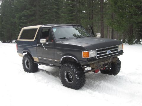 1989 Ford Bronco - This lifted 1989 Ford Bronco navigates a snowy terrain, its off-road capabilities.