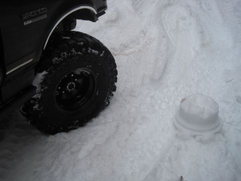 1989 Ford Bronco - 1989 Ford Bronco fender and tire in snow. The "BRONCO" badge is visible on the fender.