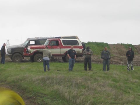 1989 Ford Bronco - A group of men stand near two vintage SUVs, possibly at an off-road event or gathering.
