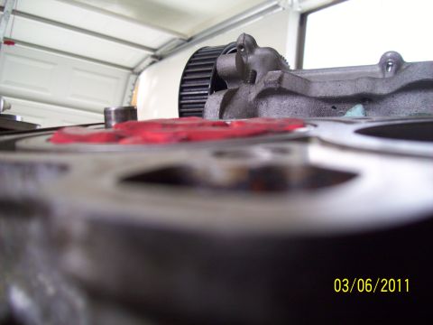 1995 Ford Probe - Close-up of an engine component with red sealant and a ribbed pulley visible.